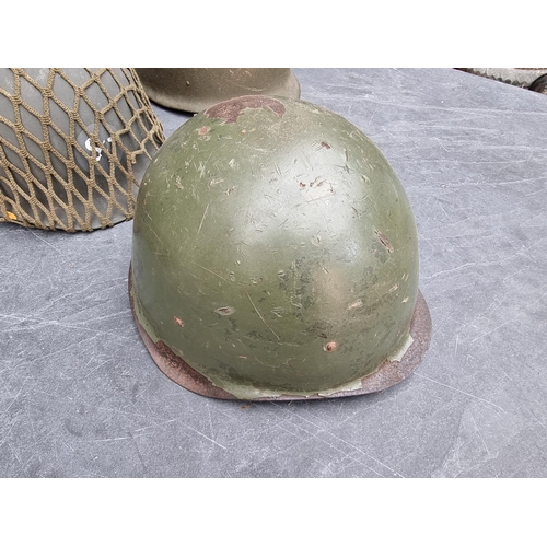 745 - Four various military steel helmets.