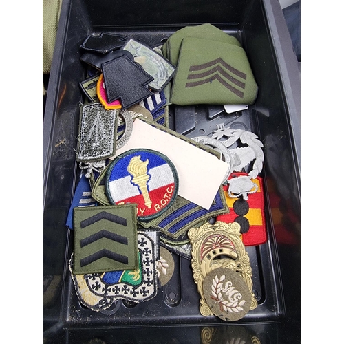 765 - A quantity of militaria, to include webbing, cloth badges etc.