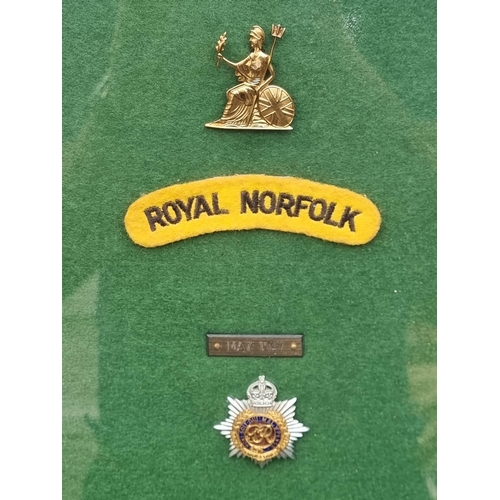 777 - A mounted group of Insignia, for the R.M.A Sandhurst, Indian Army Royal Norfolk Regiment and R.A.S.C... 