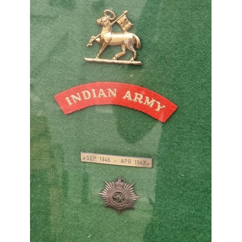 777 - A mounted group of Insignia, for the R.M.A Sandhurst, Indian Army Royal Norfolk Regiment and R.A.S.C... 