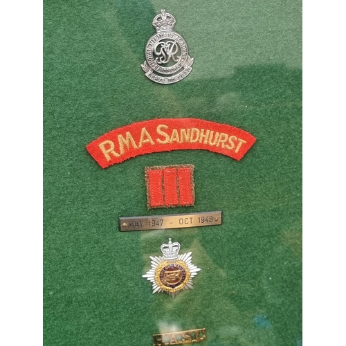 777 - A mounted group of Insignia, for the R.M.A Sandhurst, Indian Army Royal Norfolk Regiment and R.A.S.C... 