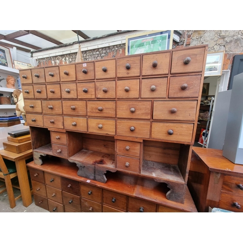 1007 - A vintage mahogany multi-drawer chest, 109cm high x 164.5cm wide x 25cm deep.