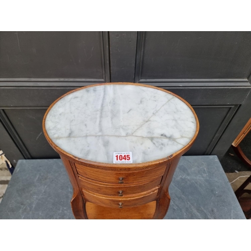 1045 - A Louis XVI style walnut and marble top gueridon, with two small lateral slides and three friez... 