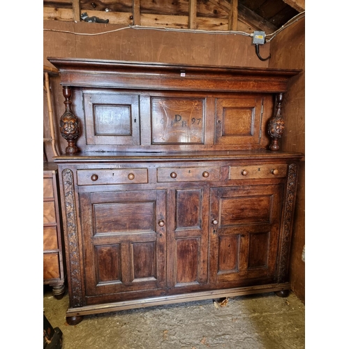 1080 - A large oak court cupboard, initialled and dated 1697, 181cm wide.