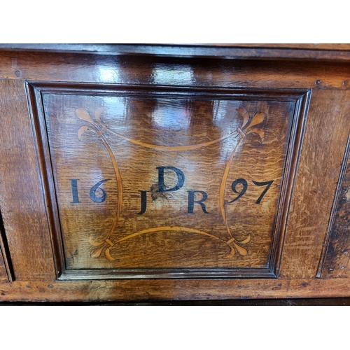 1080 - A large oak court cupboard, initialled and dated 1697, 181cm wide.