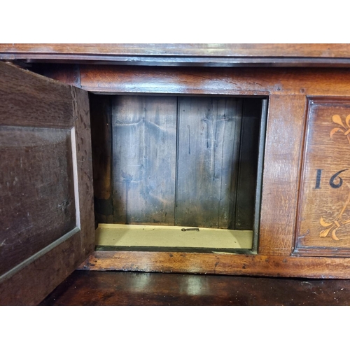 1080 - A large oak court cupboard, initialled and dated 1697, 181cm wide.