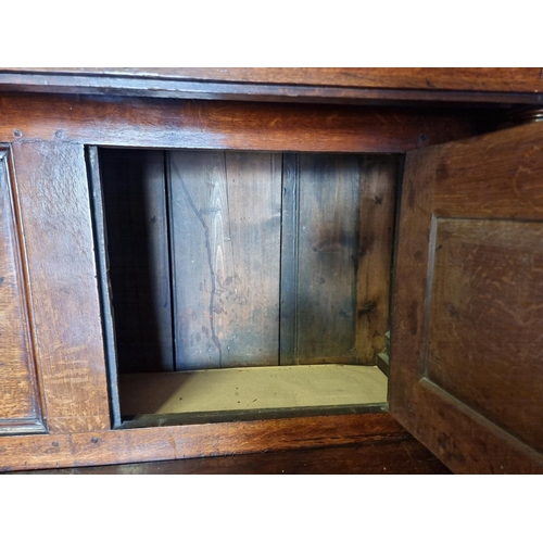 1080 - A large oak court cupboard, initialled and dated 1697, 181cm wide.