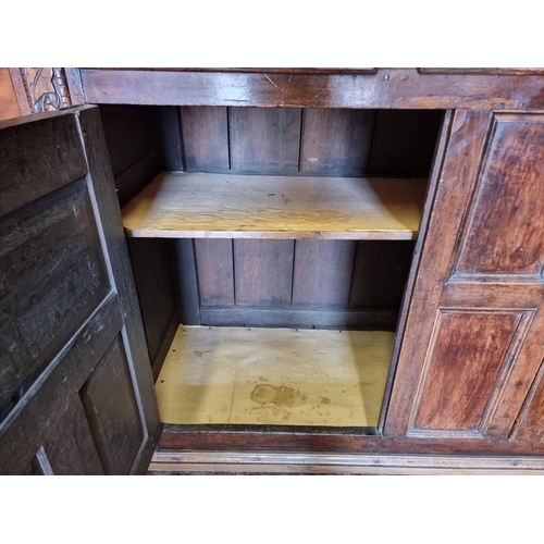 1080 - A large oak court cupboard, initialled and dated 1697, 181cm wide.