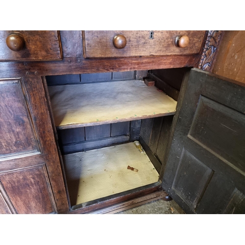 1080 - A large oak court cupboard, initialled and dated 1697, 181cm wide.