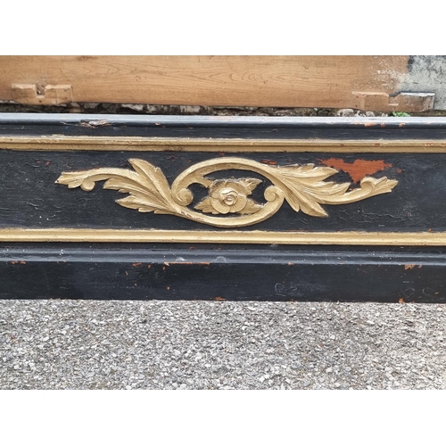 1083 - An antique continental ebonised and parcel gilt day bed, 131cm wide.