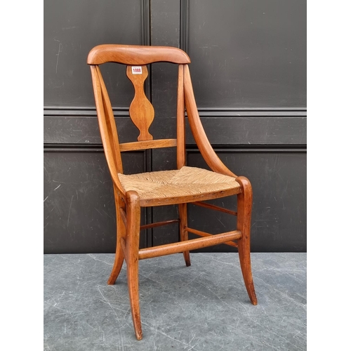 1088 - A 19th century continental fruitwood and rush seated child's chair.