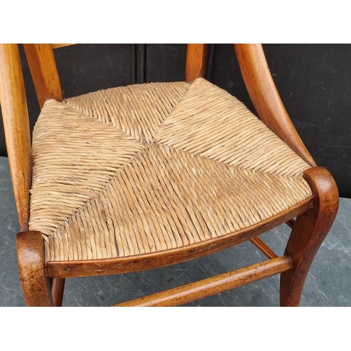 1088 - A 19th century continental fruitwood and rush seated child's chair.