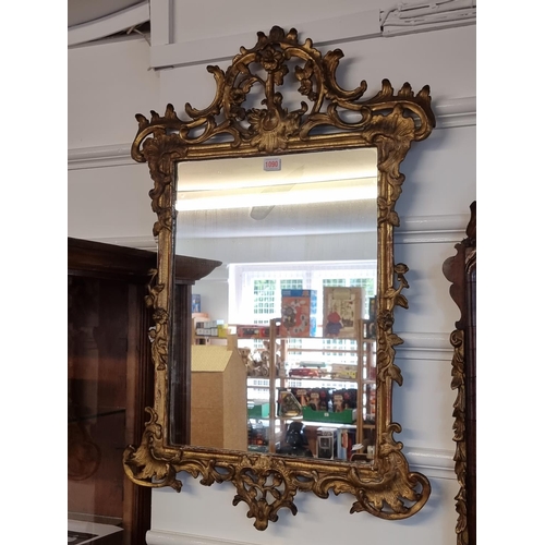 1090 - A George III carved and pierced giltwood framed wall mirror, 89 x 58.5cm.