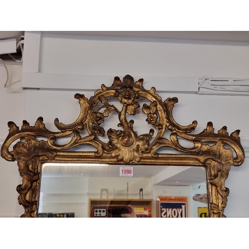 1090 - A George III carved and pierced giltwood framed wall mirror, 89 x 58.5cm.