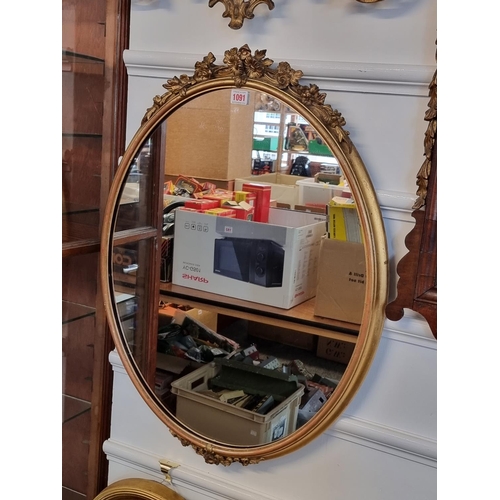 1091 - A Victorian gilt gesso framed oval wall mirror, 76 x 58cm.