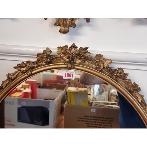 1091 - A Victorian gilt gesso framed oval wall mirror, 76 x 58cm.