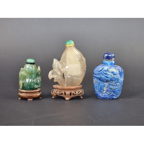 1384 - Three Chinese carved hardstone snuff bottles and stoppers, probably Qing, comprising: a lapis l... 