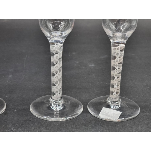 1397 - A set of four antique style double series opaque twist wine glasses, 14cm high. (4)