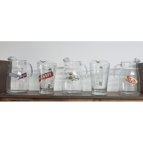 1421 - Advertising: five glass bar jugs, largest 24.5cm high.