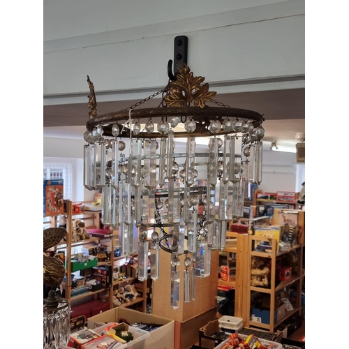 1687 - An old brass and faceted drop four tier chandelier, approx 40cm high. 