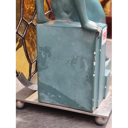 1690 - An Art Deco plaster and leaded glass figural table lamp, 33.5cm high.