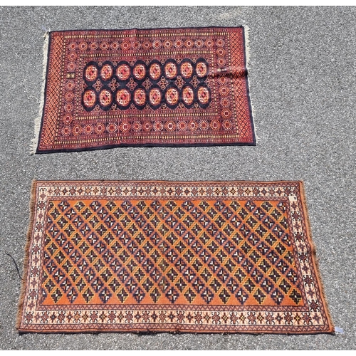 1114 - A Persian rug, having repeated decoration to central field, together with another Persian rug, havin... 