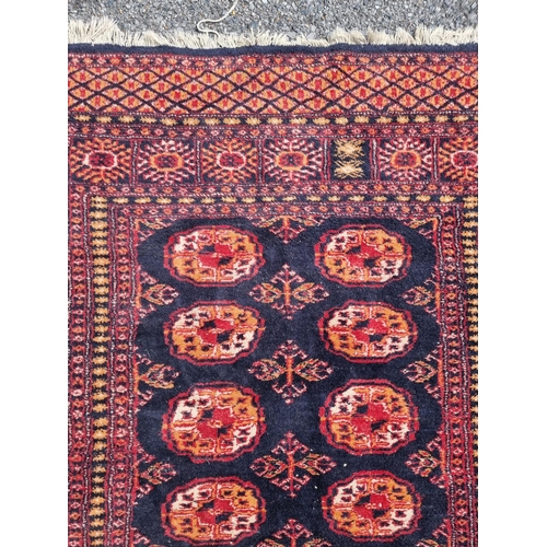 1114 - A Persian rug, having repeated decoration to central field, together with another Persian rug, havin... 