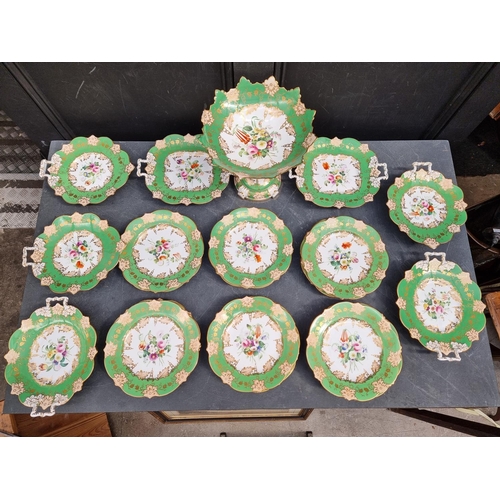 1237 - A Victorian porcelain dessert service, painted with flowers against an apple green ground, comport 2... 