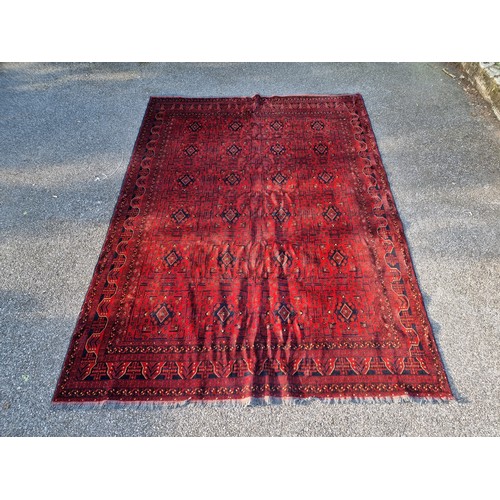 1120 - A large Afghan Khal rug, having repeated geometric decoration, 336 x 247cm.