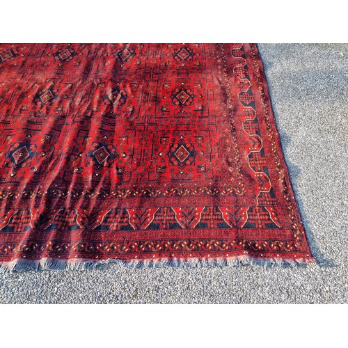 1120 - A large Afghan Khal rug, having repeated geometric decoration, 336 x 247cm.