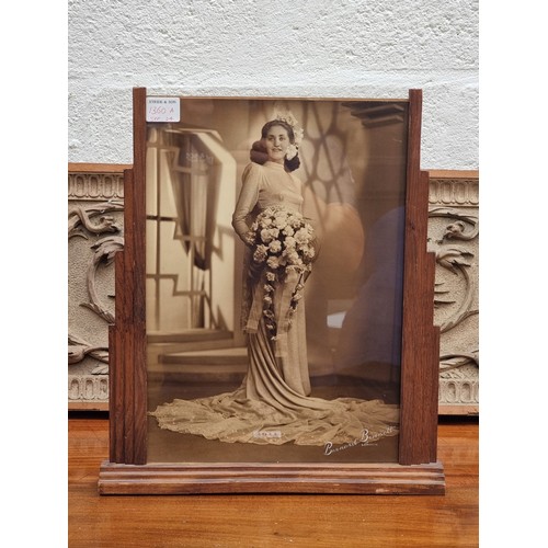 1360A - An Art Deco oak photograph frame, contained a contemporary sepia image of a lady in a wedding dress,... 