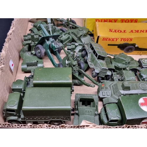 109 - Dinky: a tray of playworn military vehicles, including tanks, guns and jeeps; together with three bo... 