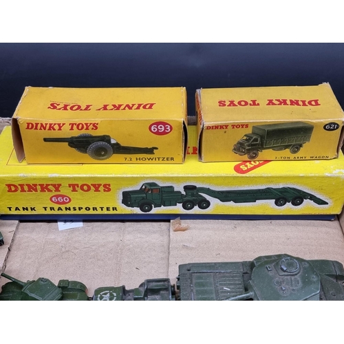 109 - Dinky: a tray of playworn military vehicles, including tanks, guns and jeeps; together with three bo... 