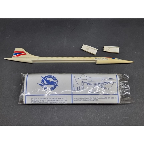 112 - Concorde: a Corgi 2 piece set No. CSCA05002; together with a British Airways 1/200 plastic model; an... 