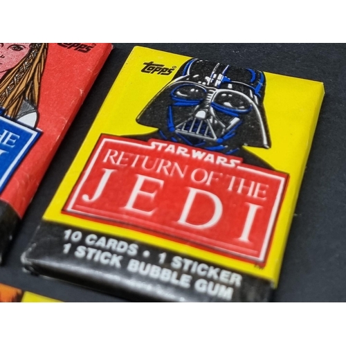 127 - Star Wars: five packs of Topps 'Return of the Jedi' bubblegum cards, 4 sealed in original waxpa... 