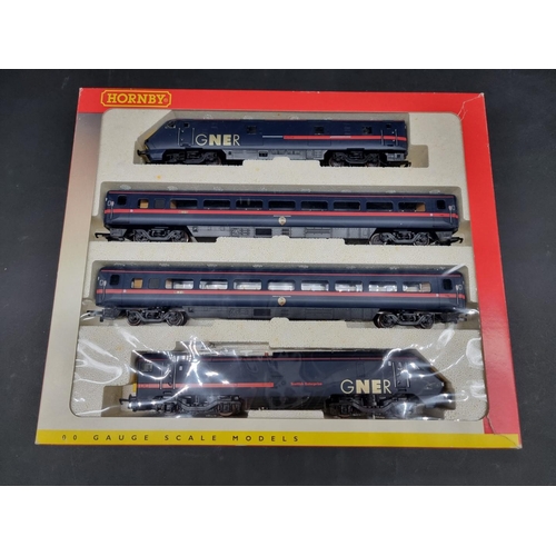 179 - Hornby: a boxed GNER train pack, R2002; together with another (three coaches only).... 