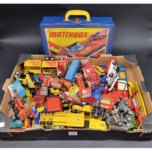 226 - Matchbox: a vintage Matchbox carry case enclosing a collection of Majorette, Matchbox and Corgi cars... 