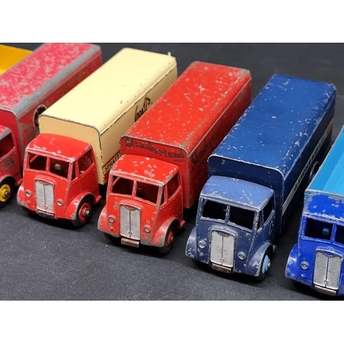 236 - Vintage Diecast: a group of eight Dinky Guy Trucks, to include 'Spratt's' and 'Slumberland' exa... 