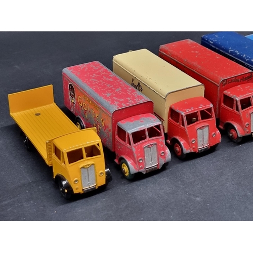 236 - Vintage Diecast: a group of eight Dinky Guy Trucks, to include 'Spratt's' and 'Slumberland' exa... 