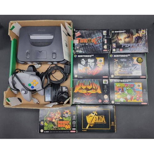 26 - Video Games: a grey Nintendo 64 console with controller, jumper pak, and cables; together with 8 gam... 