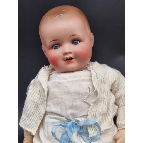 45 - Doll: an Armand Marseille bisque head doll, with straw filled cloth body, blue sleeping eyes, impres... 