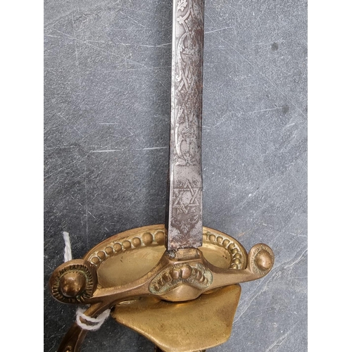 550A - A 19th century British court sword and scabbard, with 78cm etched blade and brass guard, grip and po... 