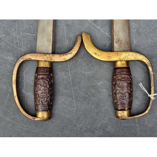 558 - An early 20th century Chinese hudiedao butterfly sword and leather sheath, with 49cm and 52cm steel ... 