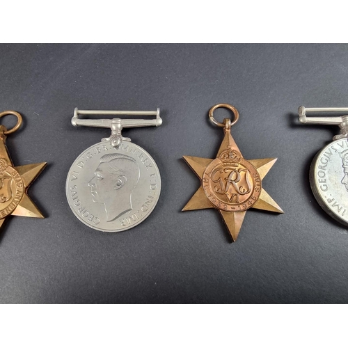 733 - Medals: a WWII group of four, in original issue box, to: R A Cooper; together with associated papers... 