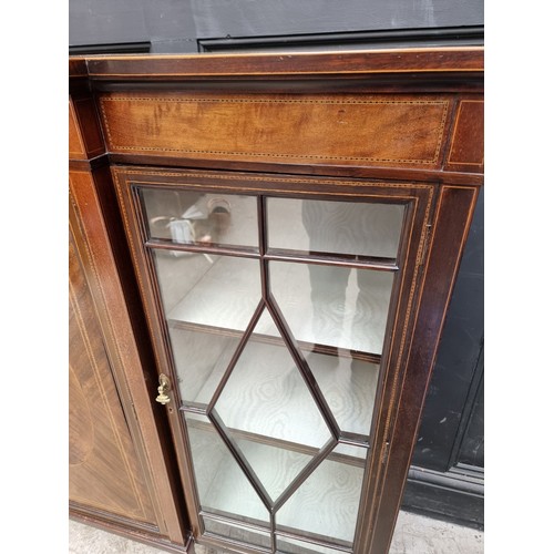 1033 - A circa 1920 mahogany and chequer strung breakfront bookcase, 137.5cm wide.