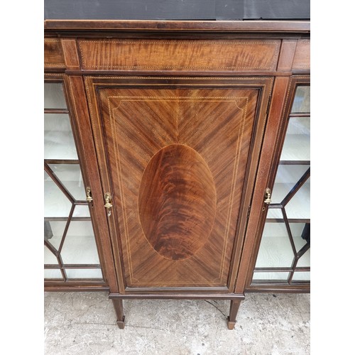 1033 - A circa 1920 mahogany and chequer strung breakfront bookcase, 137.5cm wide.