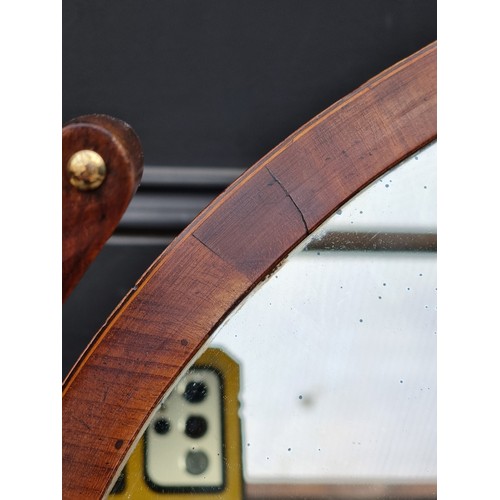 1034 - A large early 19th century mahogany and crossbanded toilet mirror, with bone escutcheon, 79cm wide.... 