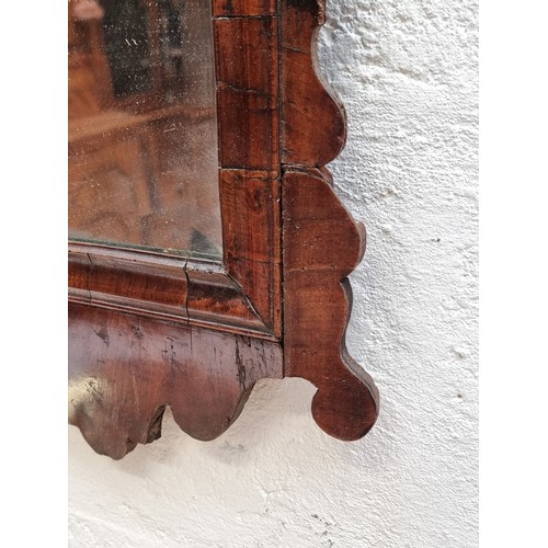 1092 - A large 18th century walnut and parcel gilt fret frame wall mirror, 117 x 56cm.