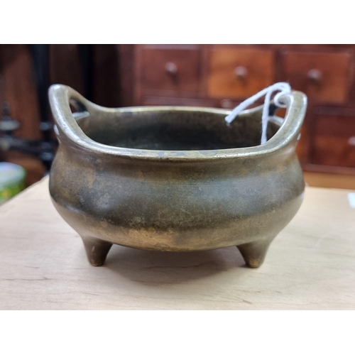 1428 - A Chinese bronze twin handled tripod censer, Xuande six character seal mark to base, 12cm diame... 