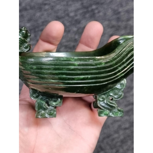 1487 - A Chinese green jade archaistic vessel, 15.5cm long; together with another hardstone figure group of... 